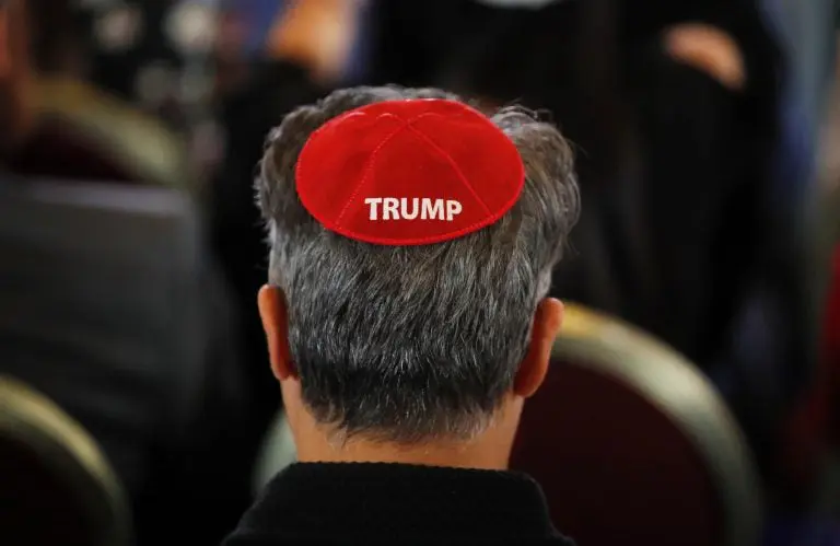 An attendee wears a yarmulke with the word 