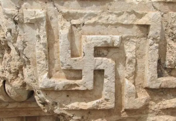 A stone carving of a symbol Description automatically generated