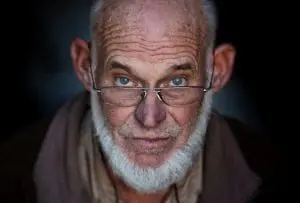 A person with glasses and a beard Description automatically generated